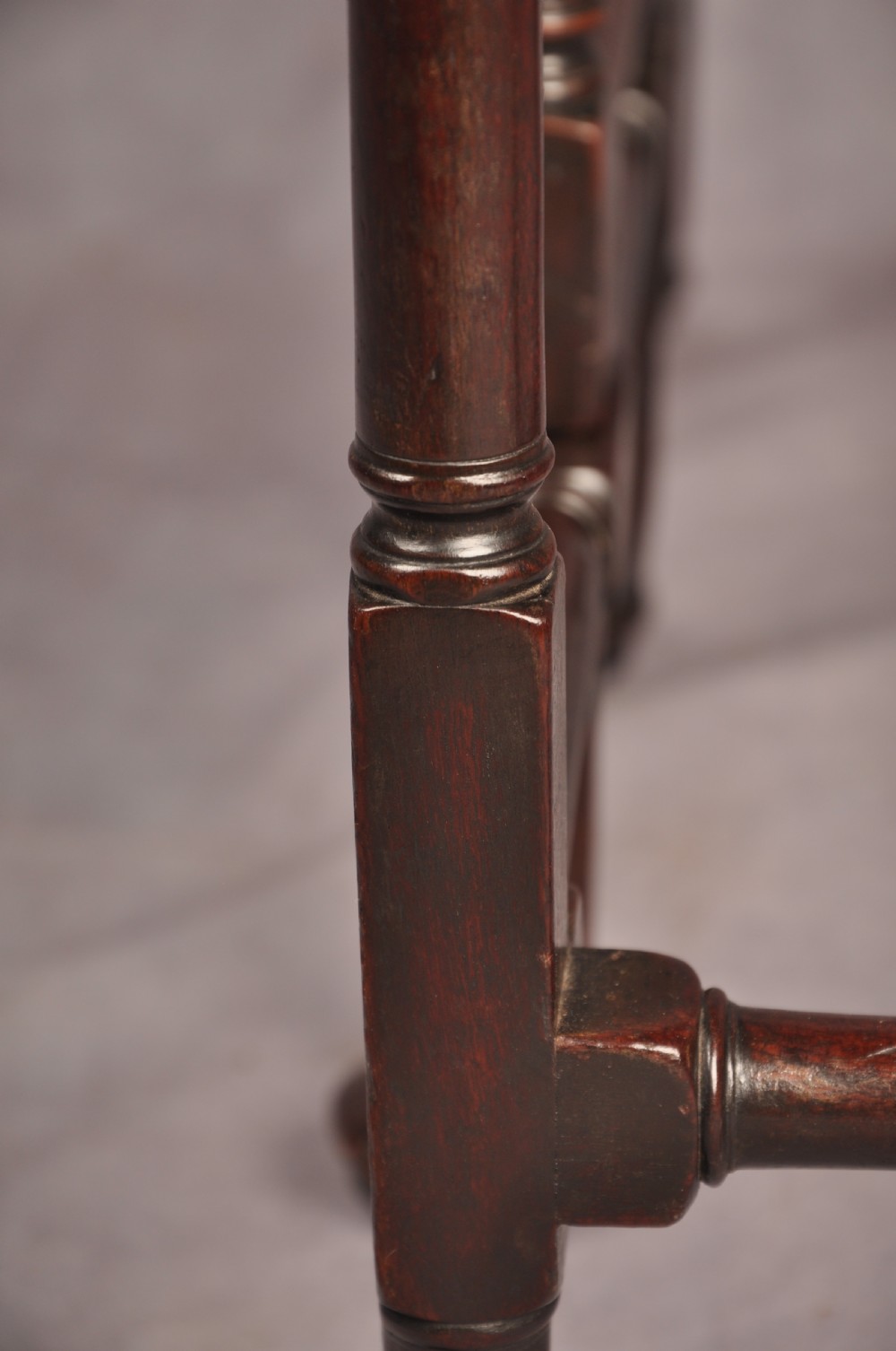 An eighteenth-century mahogany drop-leaf spider table featuring slender turned legs, cross stretchers, and pad feet. View X
