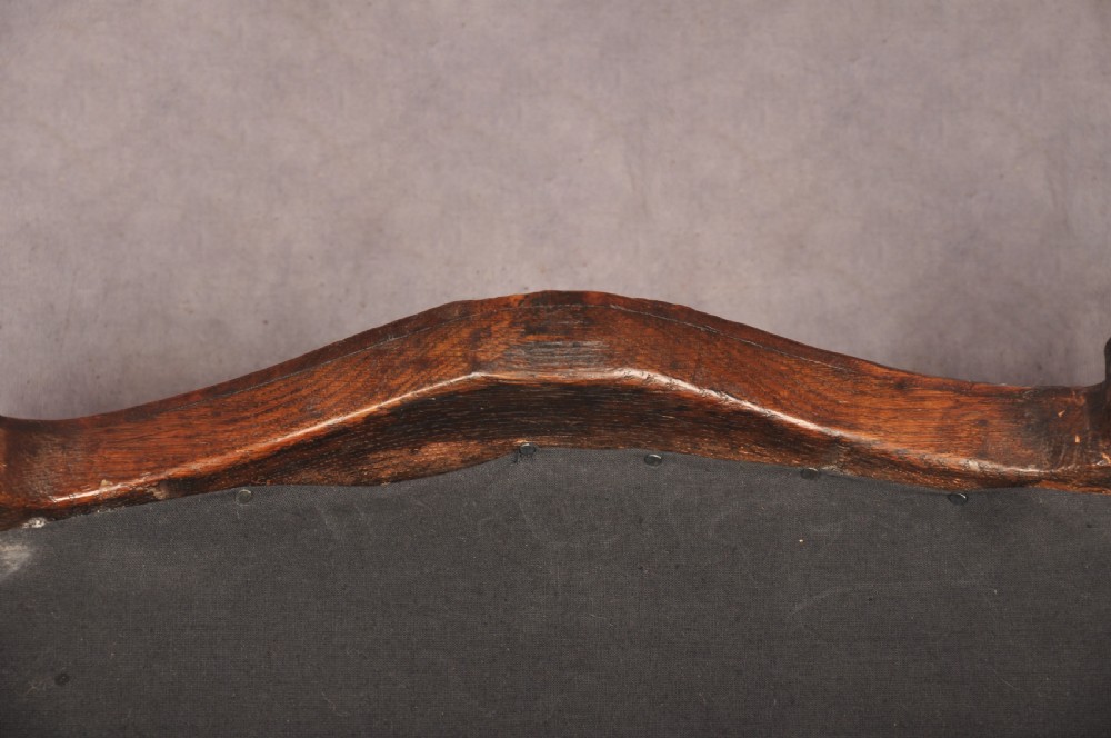 A 19th-century carved walnut stool featuring cabriole legs with claw-and-ball feet and a peach patterned upholstered top. View X