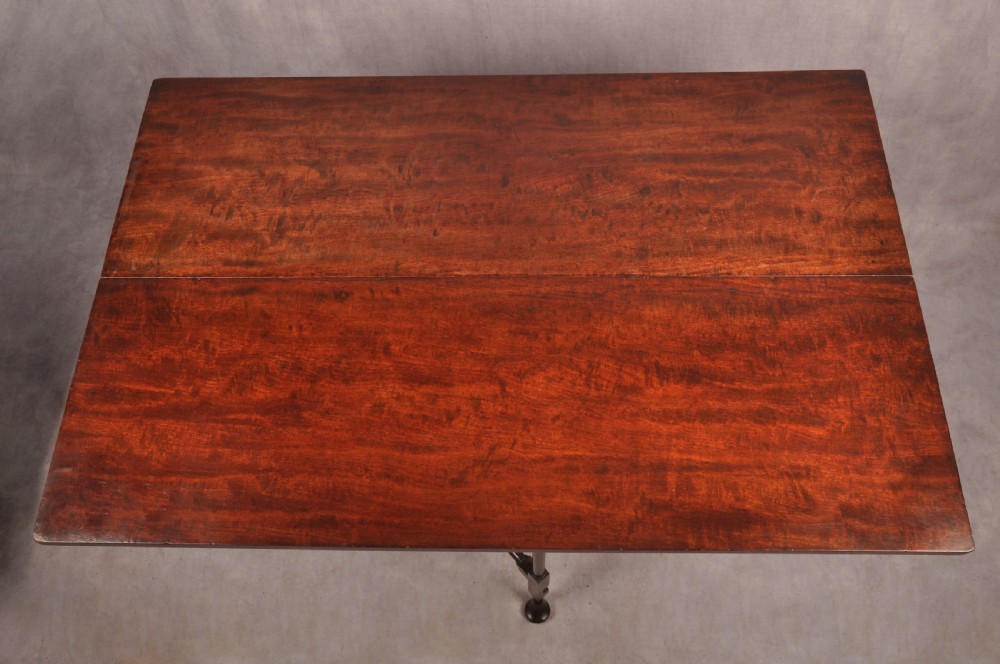 An 18th-century dark mahogany spider leg table featuring slender turned legs, curved stretchers, pad feet, and a drop-leaf top. View III