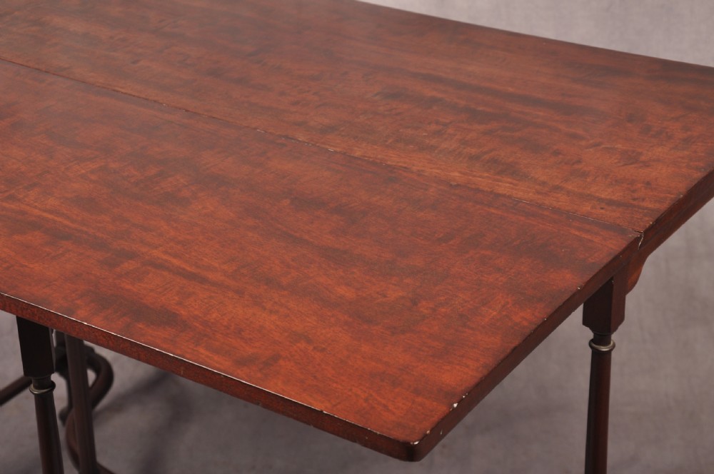 An 18th-century dark mahogany spider leg table featuring slender turned legs, curved stretchers, pad feet, and a drop-leaf top. View VI