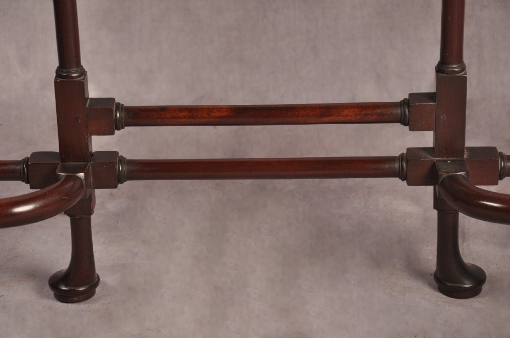 An 18th-century dark mahogany spider leg table featuring slender turned legs, curved stretchers, pad feet, and a drop-leaf top. View IX