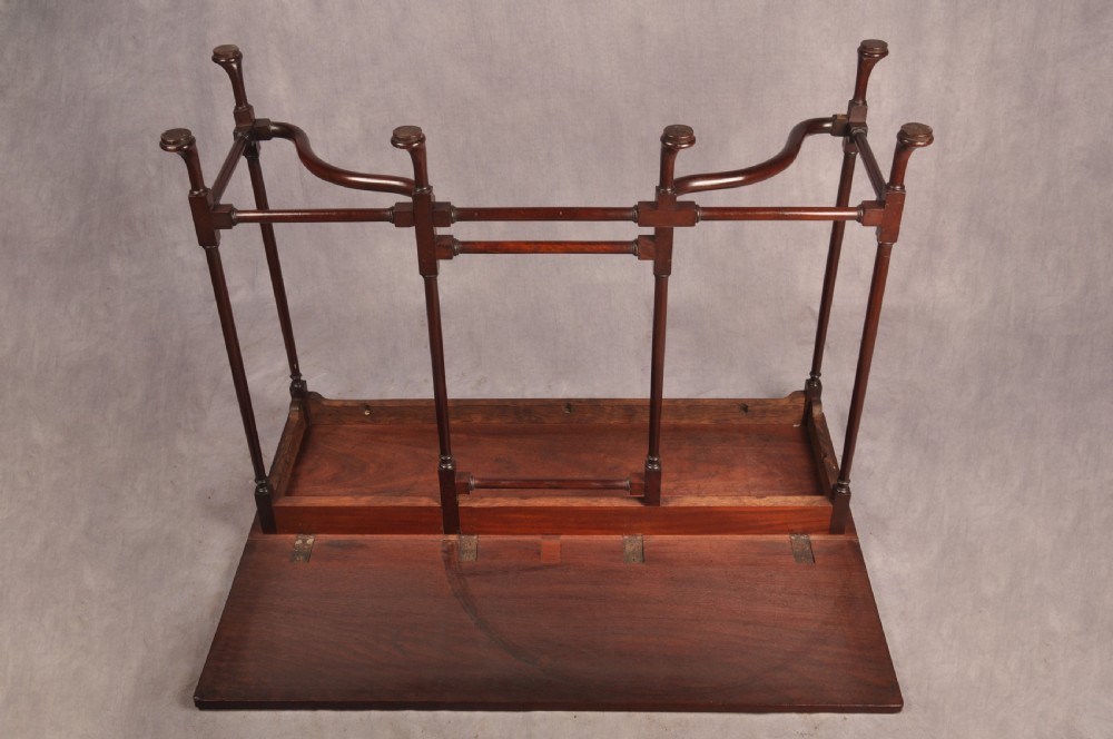 An 18th-century dark mahogany spider leg table featuring slender turned legs, curved stretchers, pad feet, and a drop-leaf top. View X