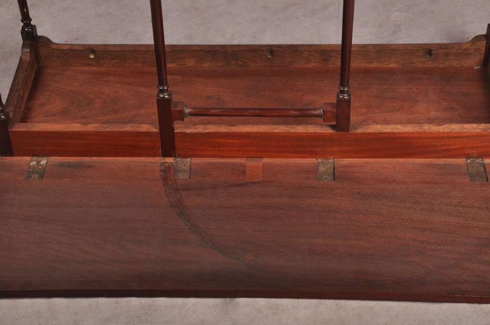 An 18th-century dark mahogany spider leg table featuring slender turned legs, curved stretchers, pad feet, and a drop-leaf top. View XI