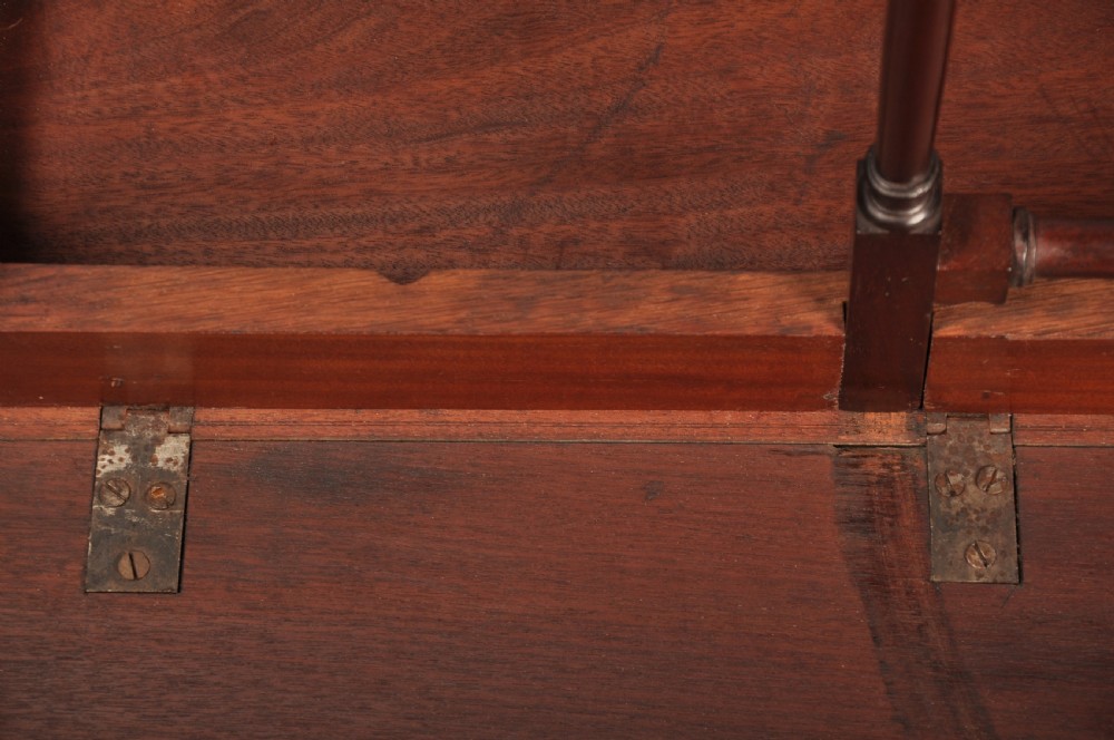 An 18th-century dark mahogany spider leg table featuring slender turned legs, curved stretchers, pad feet, and a drop-leaf top. View XII