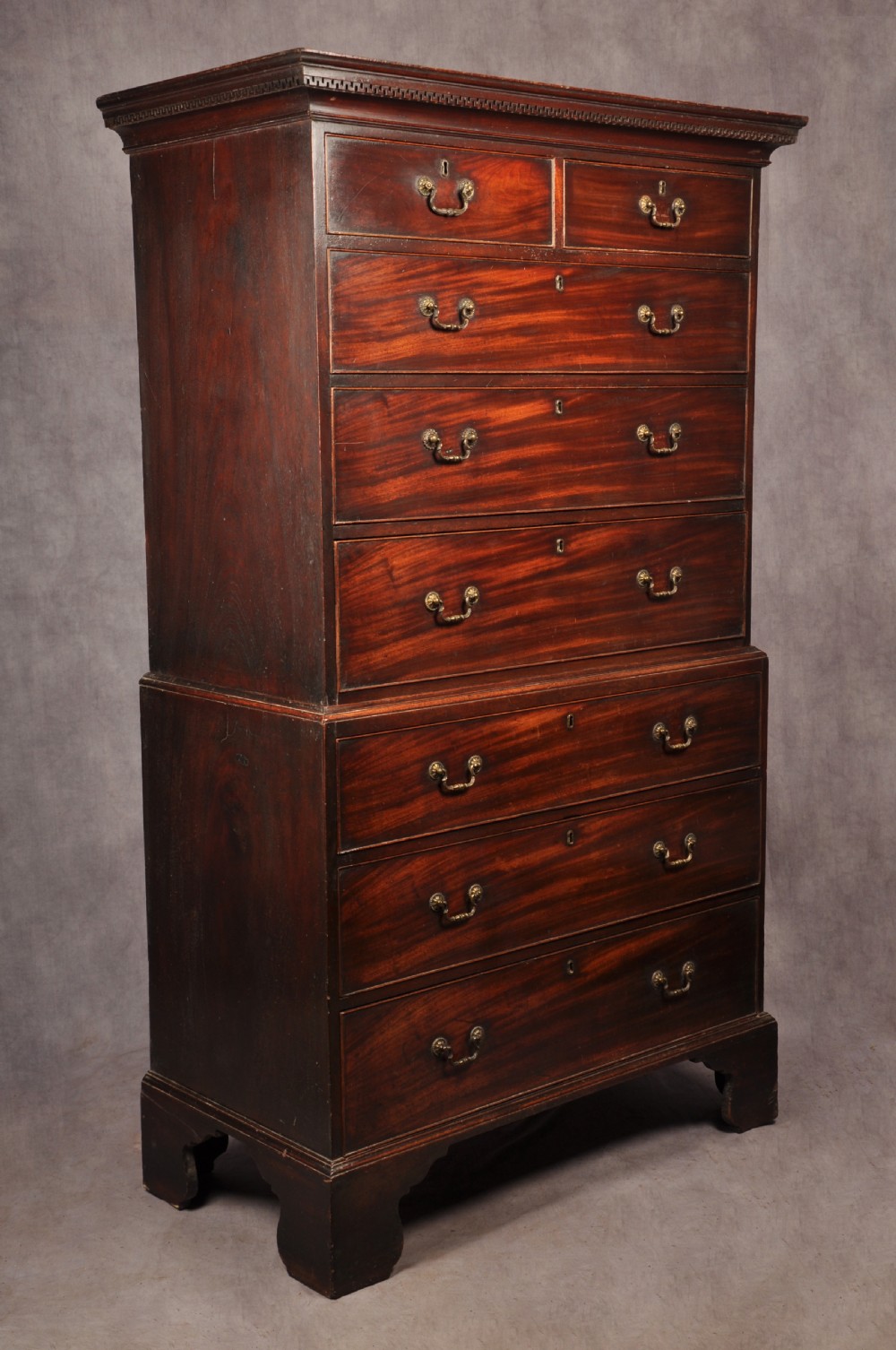 An 18th-century Georgian mahogany tallboy chest-on-chest featuring two short drawers over five long drawers with brass handles and bracket feet. View VIII