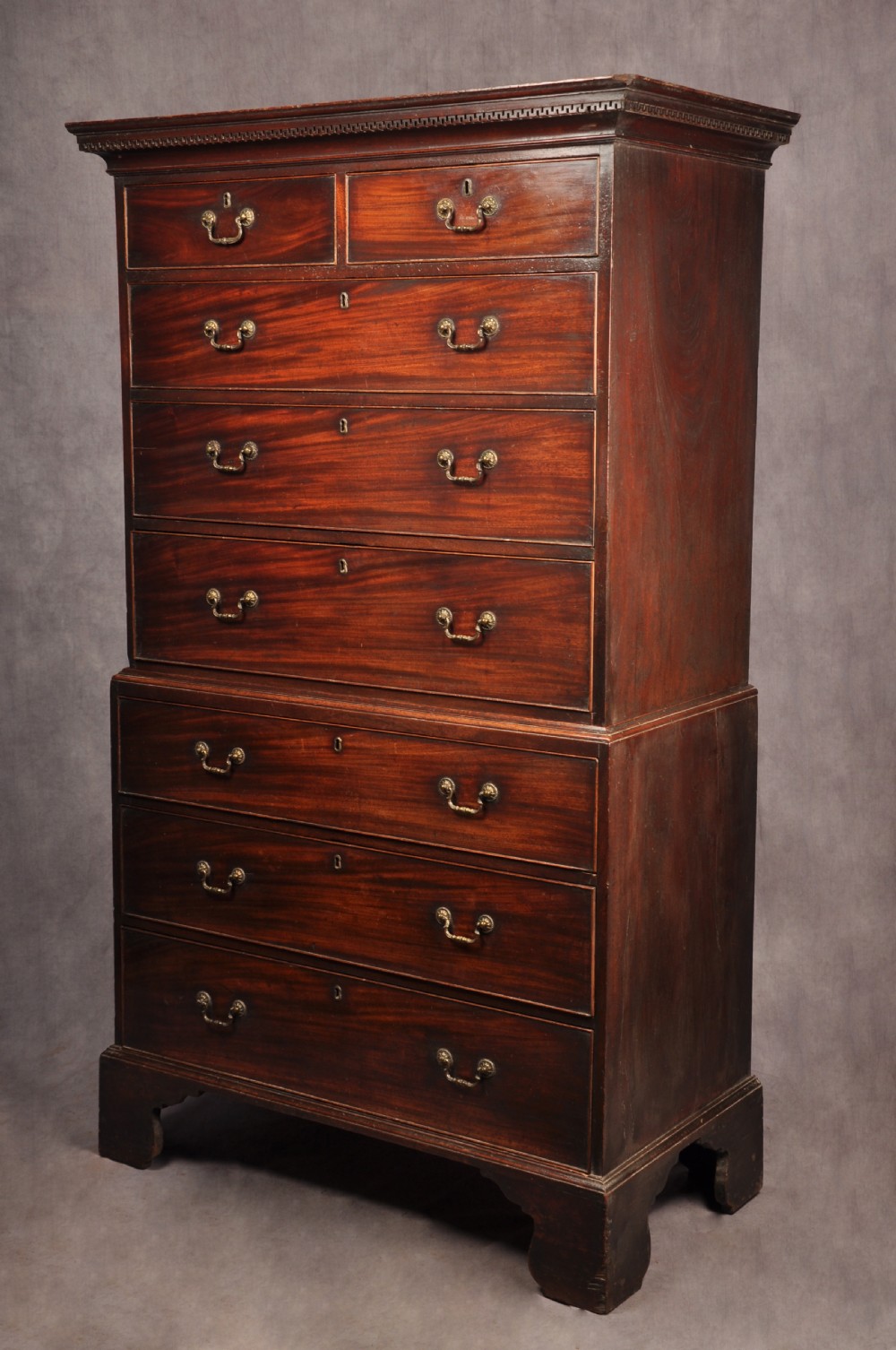 An 18th-century Georgian mahogany tallboy chest-on-chest featuring two short drawers over five long drawers with brass handles and bracket feet. View IX