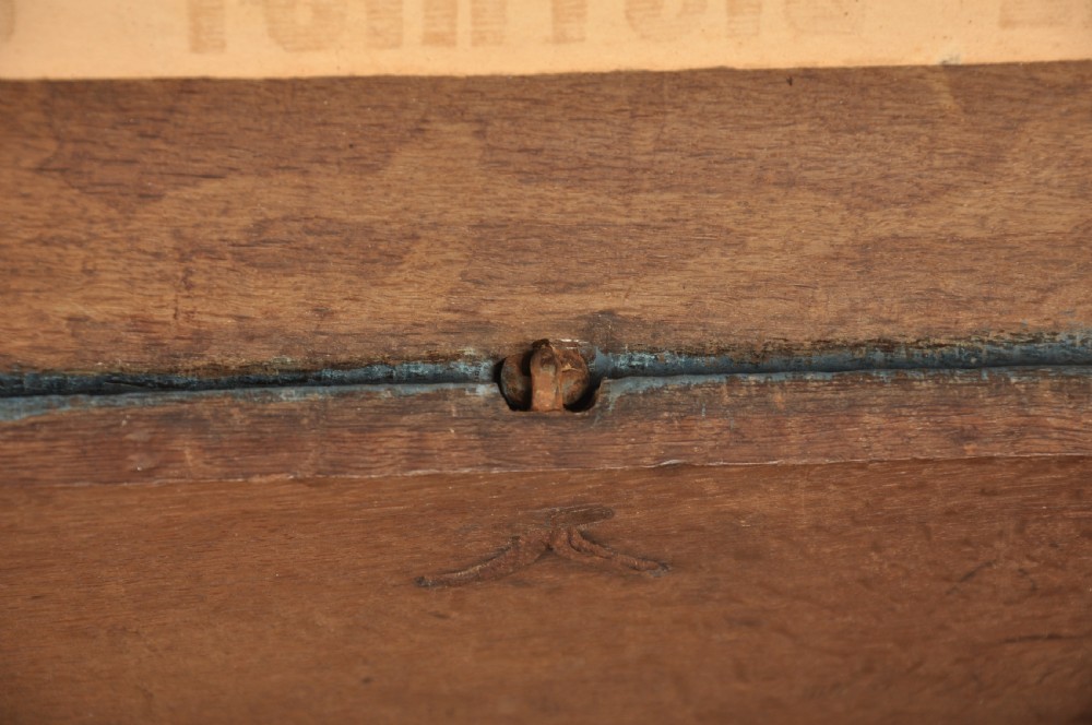 A small 17th-century dark oak coffer featuring carved lozenge and lunette patterns across the front with an iron escutcheon plate. View XI