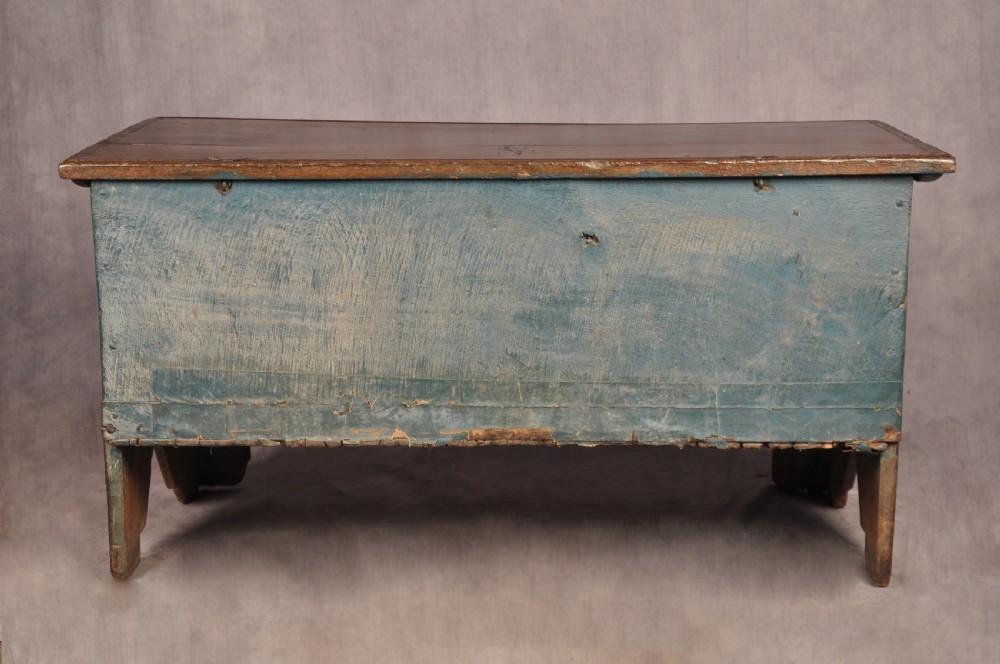 A small 17th-century dark oak coffer featuring carved lozenge and lunette patterns across the front with an iron escutcheon plate. View XIII