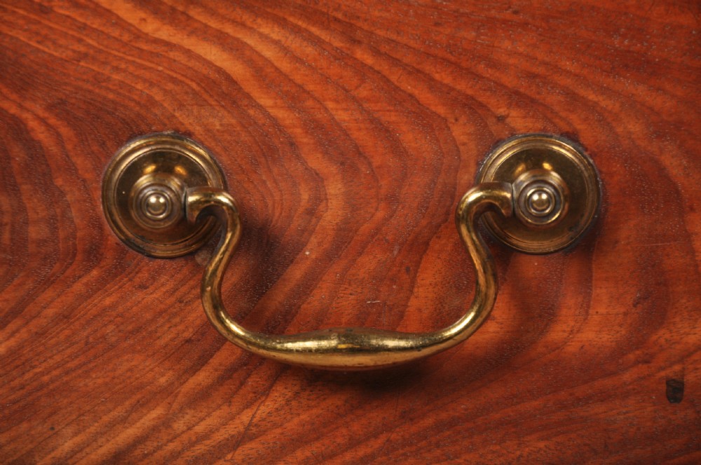 An 18th-century Georgian mahogany chest of drawers featuring four graduated drawers with brass swan-neck handles, keyholes, a pull-out brushing slide, and bracket feet. View II