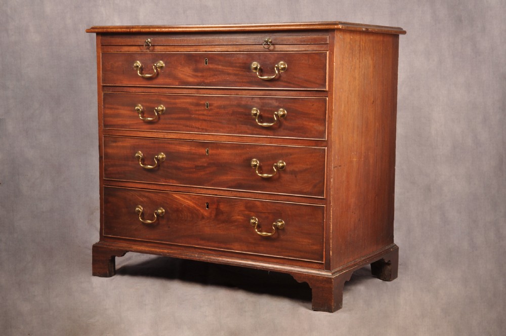 An 18th-century Georgian mahogany chest of drawers featuring four graduated drawers with brass swan-neck handles, keyholes, a pull-out brushing slide, and bracket feet. View XIII