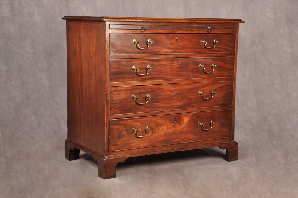 An 18th-century Georgian mahogany chest of drawers featuring four graduated drawers with brass swan-neck handles, keyholes, a pull-out brushing slide, and bracket feet. View XIV