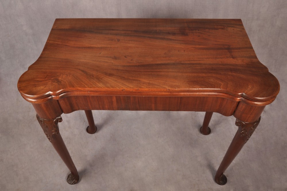 An 18th-century mahogany card table featuring a fold-over top, aproned frame, and carved cabriole legs. View II