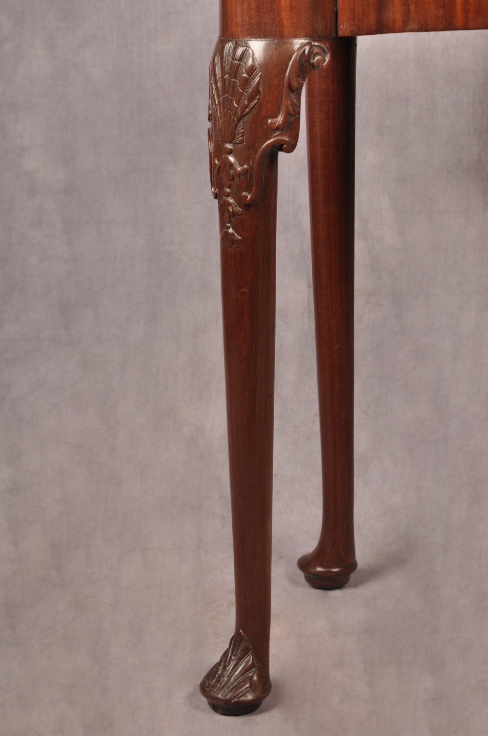 An 18th-century mahogany card table featuring a fold-over top, aproned frame, and carved cabriole legs. View III