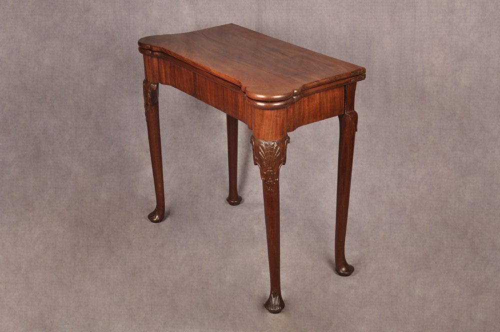 An 18th-century mahogany card table featuring a fold-over top, aproned frame, and carved cabriole legs. View XIV