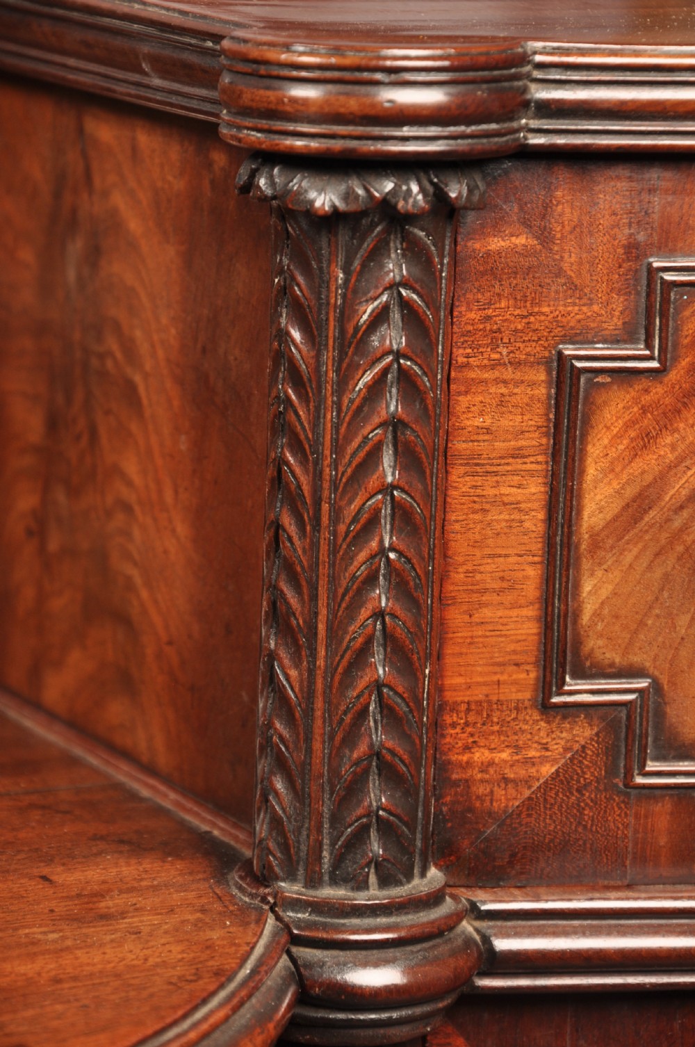 An antique Regency mahogany sideboard featuring flame mahogany panel doors, brass lion mask ring handles, spiral turned columns, hairy paw feet, and a central backboard mirror. View XII