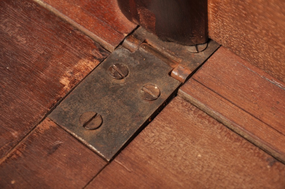 An 18th-century mahogany drop-leaf gateleg table with tapered legs, pad feet, and a scalloped apron on a plain background. View XII