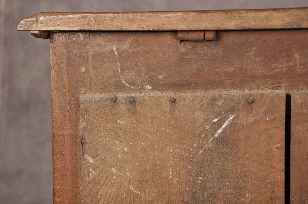 A 17th-century dark oak chest of drawers featuring geometric mouldings, split baluster details, brass drop handles, and a scalloped apron. View XXIII