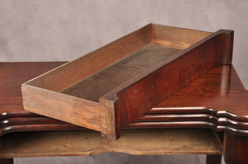 An 18th-century dark mahogany triple-top card table with shaped cabriole legs ending in pad feet. View XII