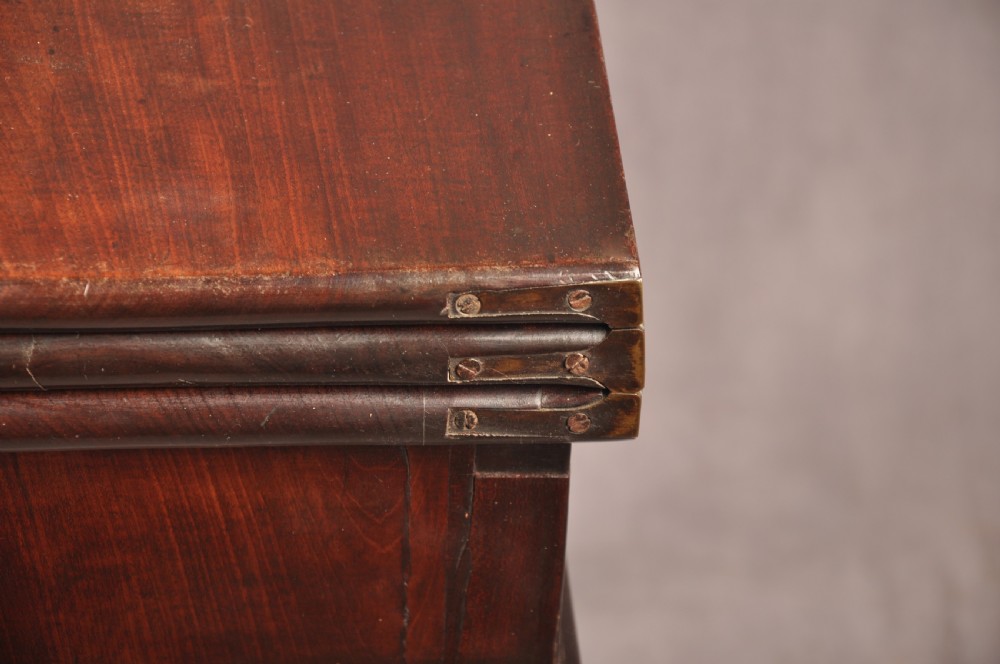 An 18th-century dark mahogany triple-top card table with shaped cabriole legs ending in pad feet. View XIV