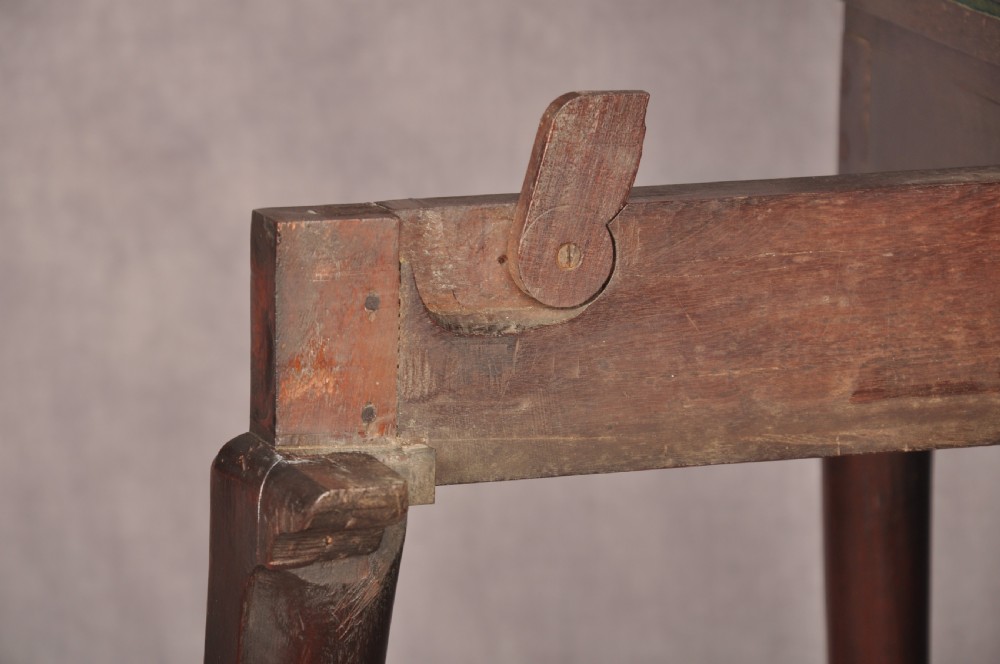 An 18th-century dark mahogany triple-top card table with shaped cabriole legs ending in pad feet. View XVII