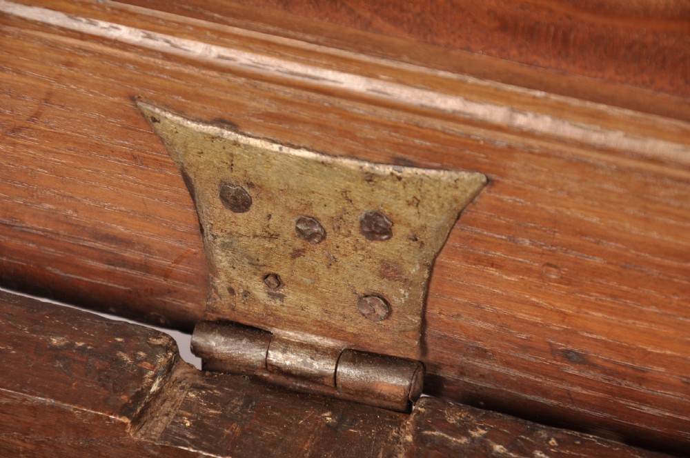 A 17th-century dark oak coffer featuring three carved arcaded panels with central diamond lozenge designs and carved lunette friezes. View IX