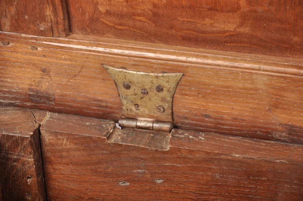 A 17th-century dark oak coffer featuring three carved arcaded panels with central diamond lozenge designs and carved lunette friezes. View X