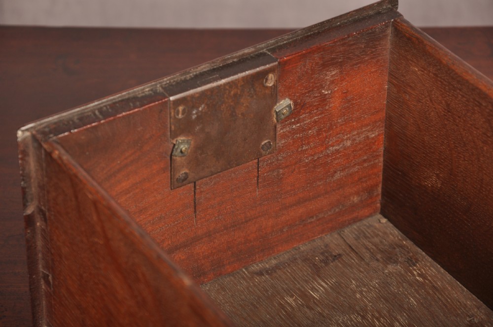 An early 18th-century mahogany lowboy with three drawers, brass handles, a shaped apron, and four cabriole legs with pad feet. View V