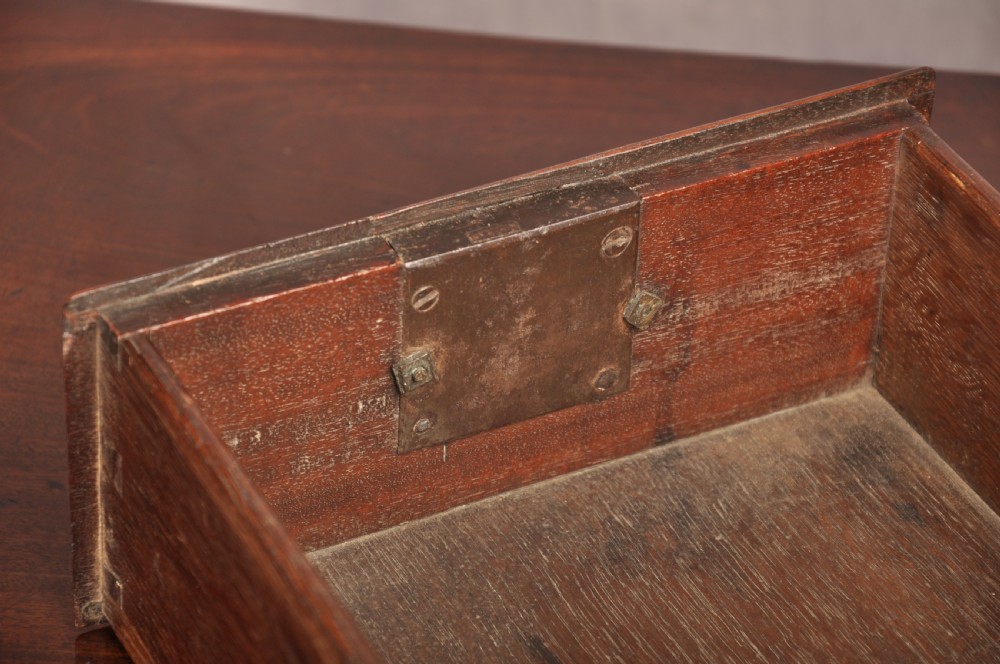 An early 18th-century mahogany lowboy with three drawers, brass handles, a shaped apron, and four cabriole legs with pad feet. View VI