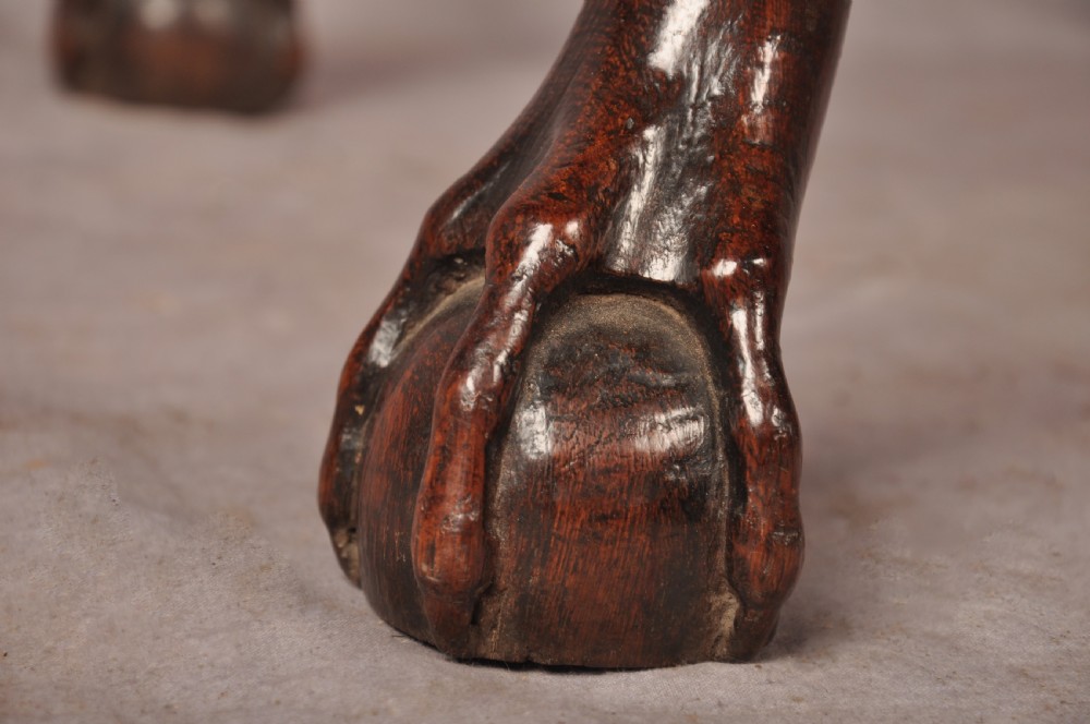 An early 18th-century dark oak lowboy side table featuring three drawers with brass drop handles, a shaped apron, and four cabriole legs. View VIII