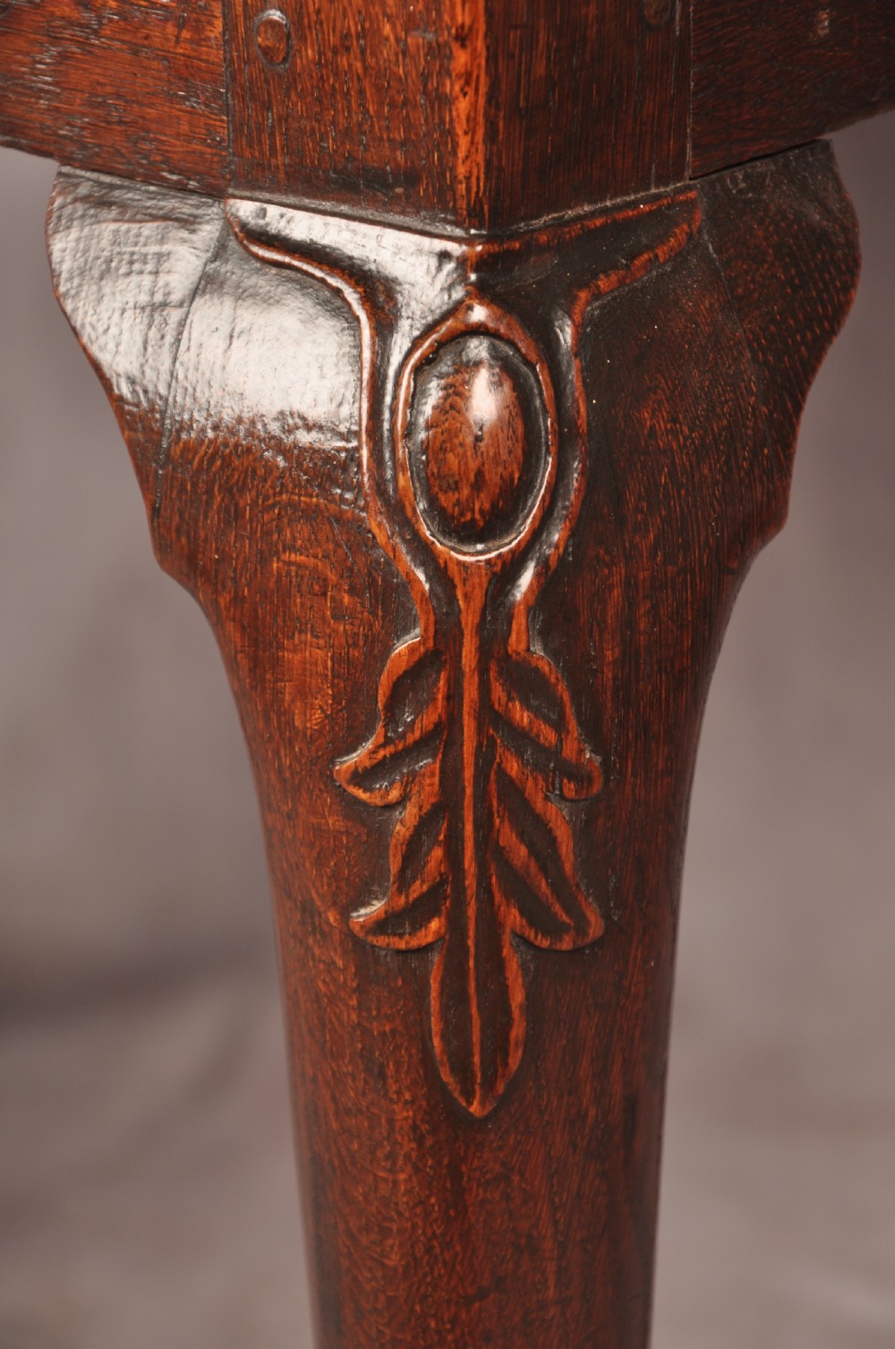 An early 18th-century dark oak lowboy side table featuring three drawers with brass drop handles, a shaped apron, and four cabriole legs. View IX