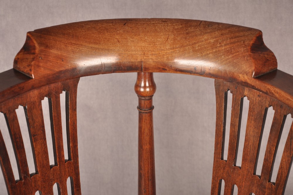 An 18th-century dark wood corner chair featuring a curved horseshoe backrest, dual pierced splats, turned uprights, fluted legs, and a patterned needlepoint drop-in seat. View IV
