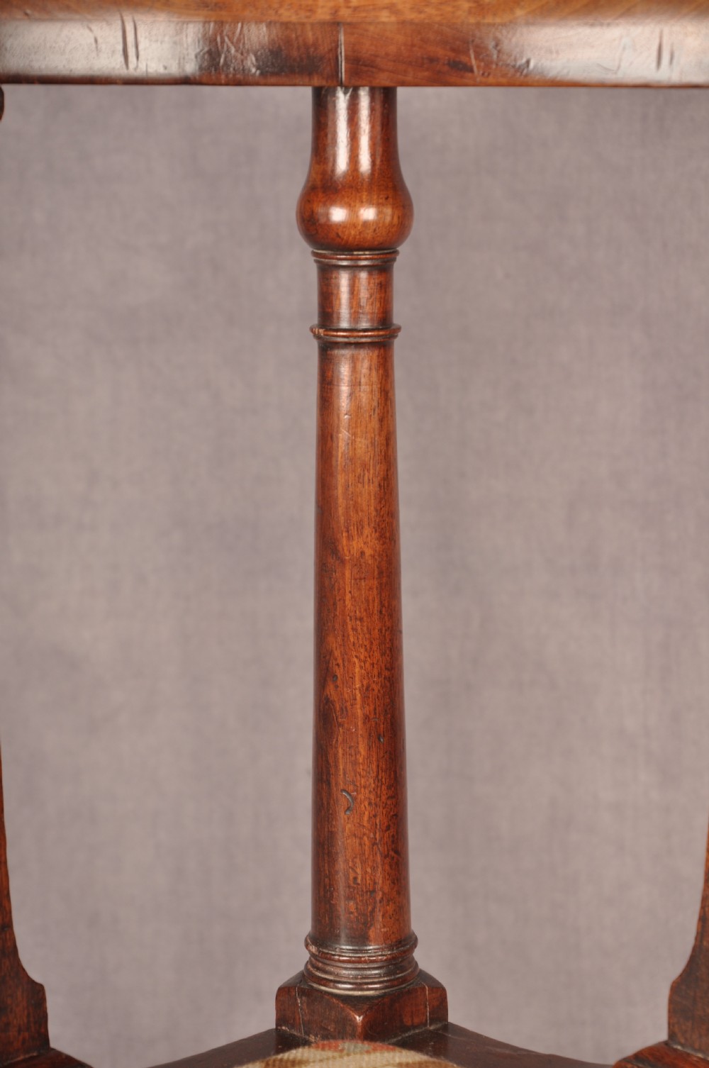 An 18th-century dark wood corner chair featuring a curved horseshoe backrest, dual pierced splats, turned uprights, fluted legs, and a patterned needlepoint drop-in seat. View V