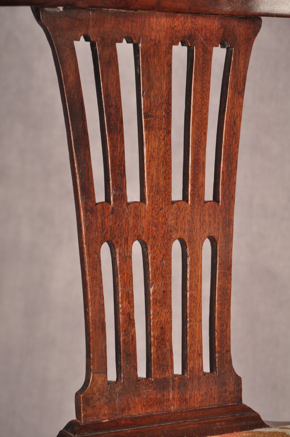 An 18th-century dark wood corner chair featuring a curved horseshoe backrest, dual pierced splats, turned uprights, fluted legs, and a patterned needlepoint drop-in seat. View VII