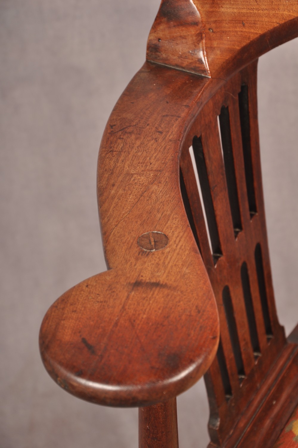 An 18th-century dark wood corner chair featuring a curved horseshoe backrest, dual pierced splats, turned uprights, fluted legs, and a patterned needlepoint drop-in seat. View IX