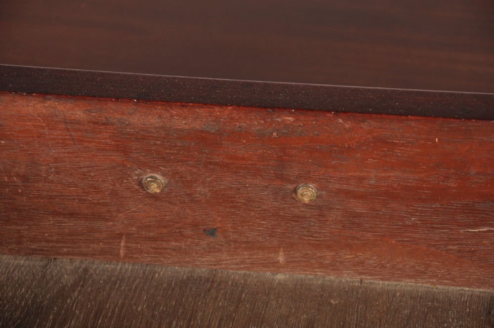 An 18th-century mahogany kneehole desk featuring multiple drawers with brass swan-neck handles, a central recessed cupboard, and bracket feet. View IX
