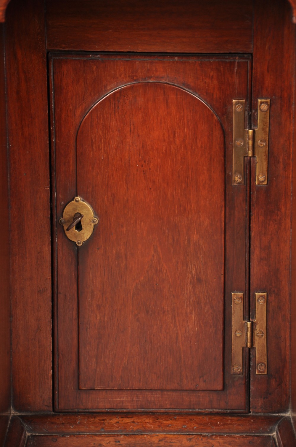 An 18th-century mahogany kneehole desk featuring multiple drawers with brass swan-neck handles, a central recessed cupboard, and bracket feet. View XI
