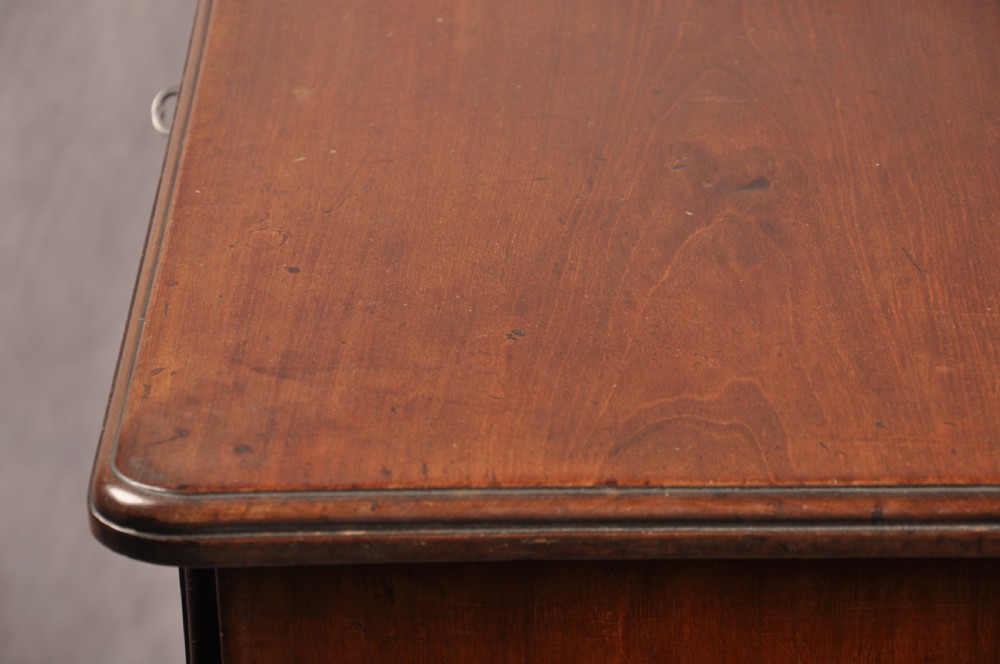 An 18th-century mahogany kneehole desk featuring multiple drawers with brass swan-neck handles, a central recessed cupboard, and bracket feet. View XIII