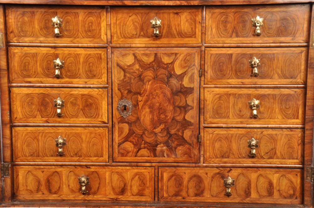 A 17th-century olive wood cabinet on stand featuring double doors inlaid with oval oyster veneer medallions, a lower drawer, turned legs, stretchers, and ball feet. View III
