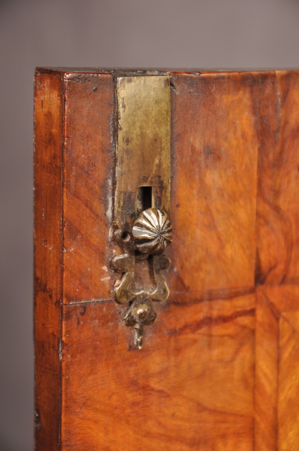 A 17th-century olive wood cabinet on stand featuring double doors inlaid with oval oyster veneer medallions, a lower drawer, turned legs, stretchers, and ball feet. View VII