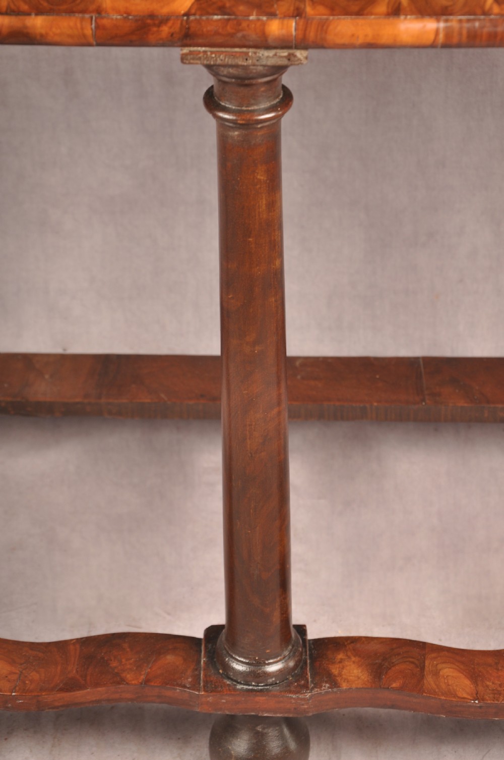 A 17th-century olive wood cabinet on stand featuring double doors inlaid with oval oyster veneer medallions, a lower drawer, turned legs, stretchers, and ball feet. View XVIII