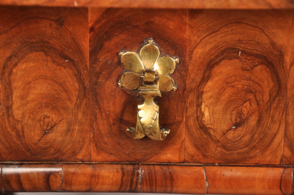 A 17th-century olive wood cabinet on stand featuring double doors inlaid with oval oyster veneer medallions, a lower drawer, turned legs, stretchers, and ball feet. View XXII