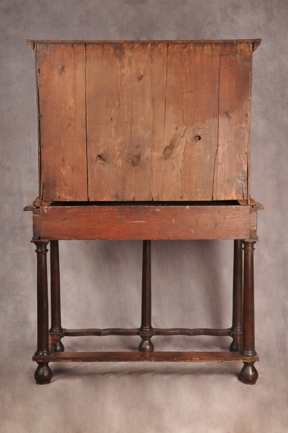 A 17th-century olive wood cabinet on stand featuring double doors inlaid with oval oyster veneer medallions, a lower drawer, turned legs, stretchers, and ball feet. View XXIV
