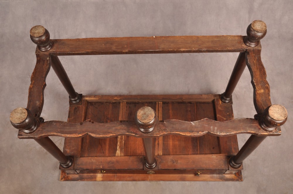 A 17th-century olive wood cabinet on stand featuring double doors inlaid with oval oyster veneer medallions, a lower drawer, turned legs, stretchers, and ball feet. View XXV