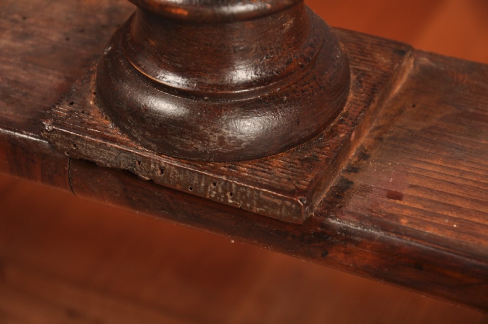 A 17th-century olive wood cabinet on stand featuring double doors inlaid with oval oyster veneer medallions, a lower drawer, turned legs, stretchers, and ball feet. View XXVIII