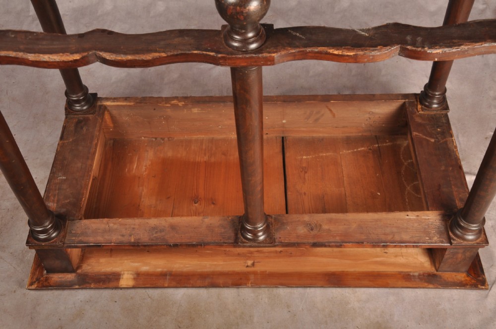 A 17th-century olive wood cabinet on stand featuring double doors inlaid with oval oyster veneer medallions, a lower drawer, turned legs, stretchers, and ball feet. View XXIX