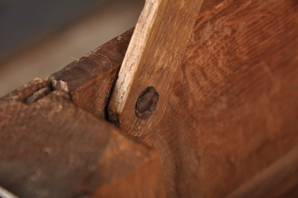A 17th century carved oak coffer featuring three lozenge-carved front panels, leaf motifs, and ebonised detailing. View VIII