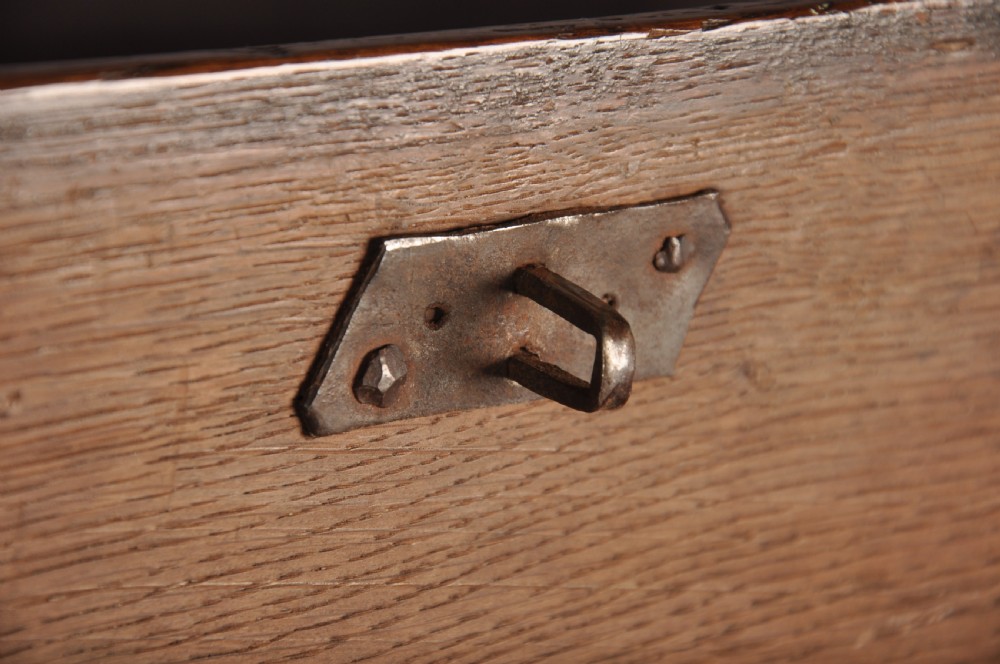 A 17th century carved oak coffer featuring three lozenge-carved front panels, leaf motifs, and ebonised detailing. View XI