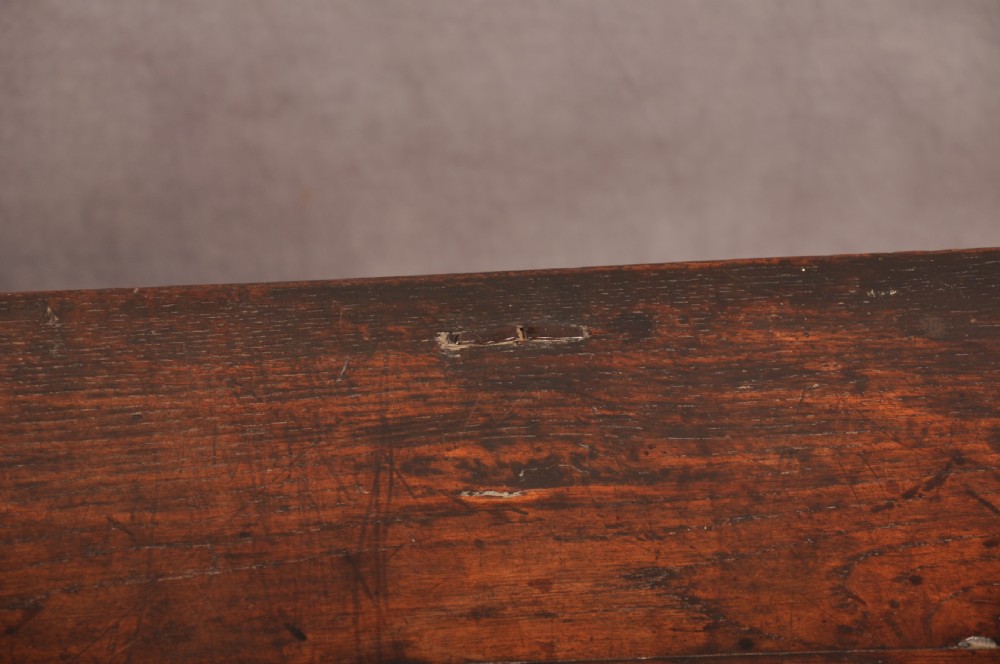 A 17th century carved oak coffer featuring three lozenge-carved front panels, leaf motifs, and ebonised detailing. View XIV