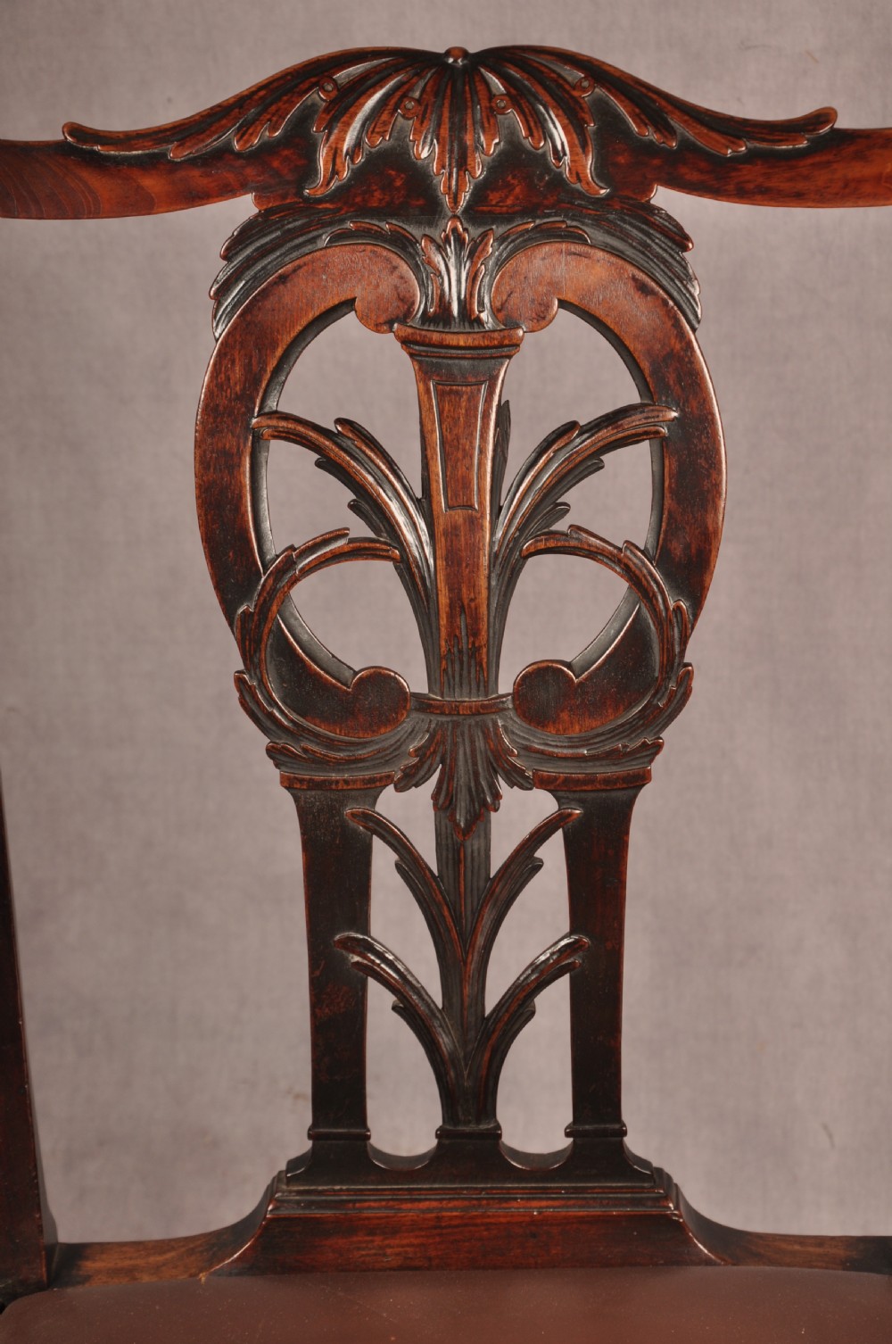 An 18th-century Chippendale carved mahogany armchair with a pierced splat, carved stretcher base, curved arms, and a warm brown leather seat. View II