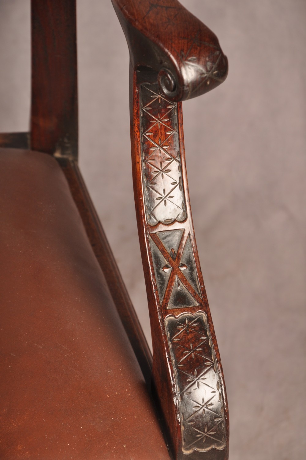 An 18th-century Chippendale carved mahogany armchair with a pierced splat, carved stretcher base, curved arms, and a warm brown leather seat. View III